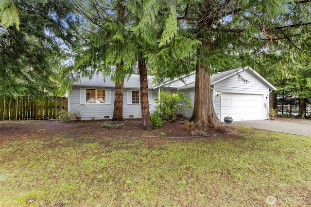 ranch-style house with fence, an attached garage, crawl space, driveway, and a front lawn