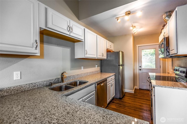 600 Harrison St, Friday Harbor, WA 98250 - kitchen with dark wood-type flooring, light stone counters, white cabinets, stainless steel appliances, and a sink