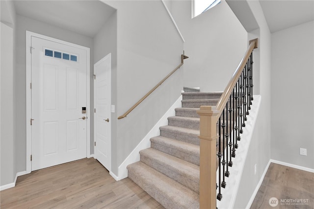 32898 Pine Ave SE, Black Diamond, WA 98010 - foyer entrance with wood finished floors, baseboards, visible vents, and stairway