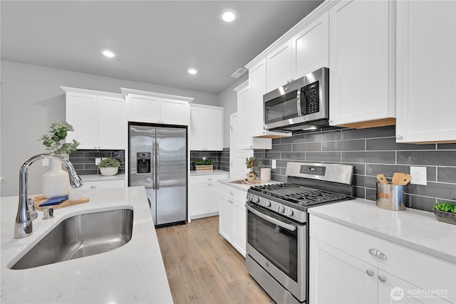 32898 Pine Ave SE, Black Diamond, WA 98010 - kitchen with appliances with stainless steel finishes, a sink, and white cabinets
