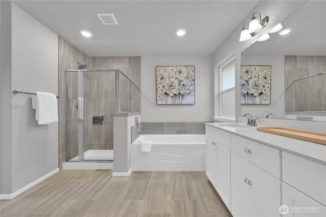 32898 Pine Ave SE, Black Diamond, WA 98010 - full bath featuring visible vents, a bath, a shower stall, and vanity
