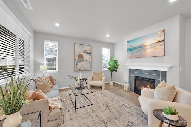 32898 Pine Ave SE, Black Diamond, WA 98010 - living area with recessed lighting, plenty of natural light, wood finished floors, and a tile fireplace