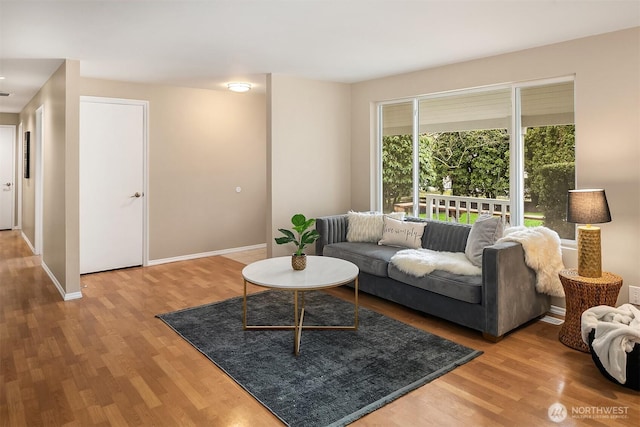 living room featuring wood finished floors and baseboards