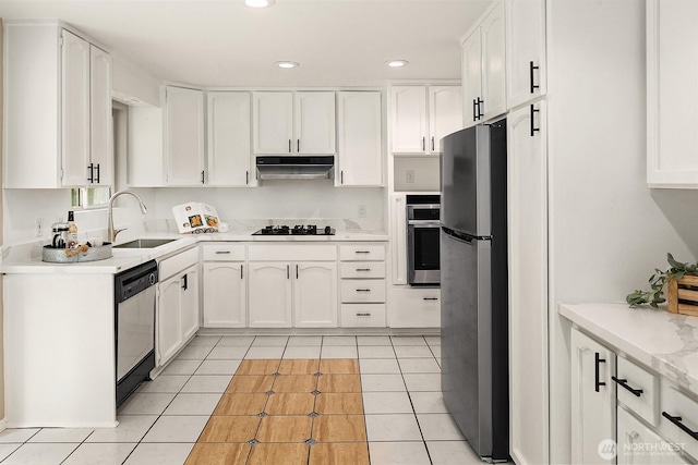 kitchen with under cabinet range hood, light tile patterned floors, white cabinets, and appliances with stainless steel finishes