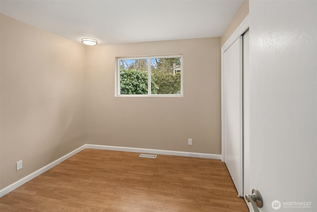 unfurnished bedroom with visible vents, baseboards, light wood-style floors, and a closet