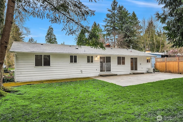 back of property featuring a patio area, a lawn, cooling unit, and fence