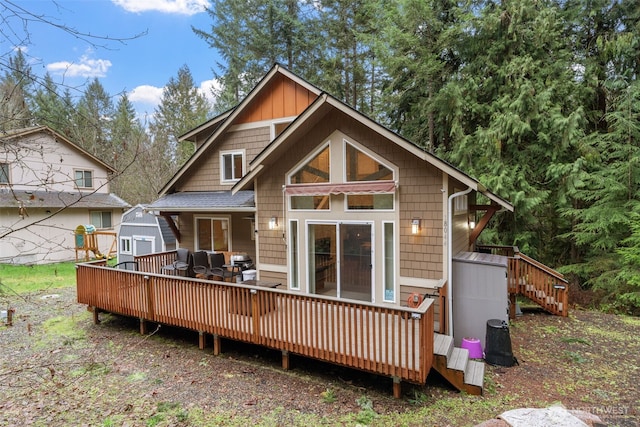 rear view of property featuring a wooden deck