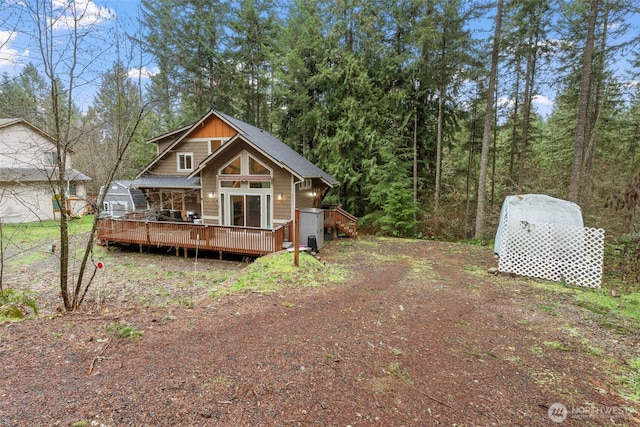 back of house featuring a wooden deck