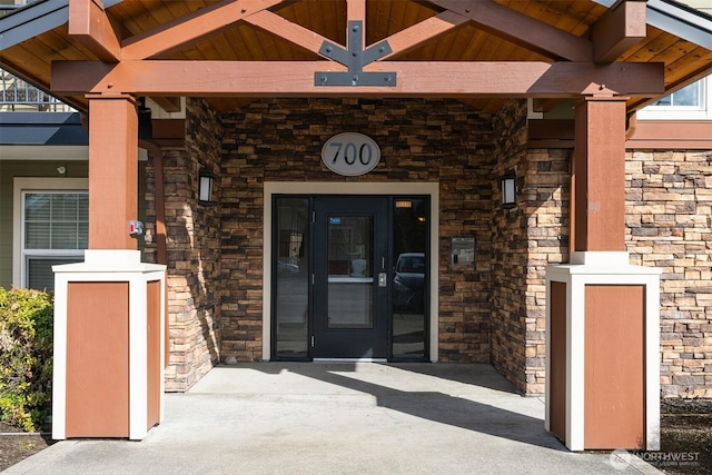 entrance to property with stone siding