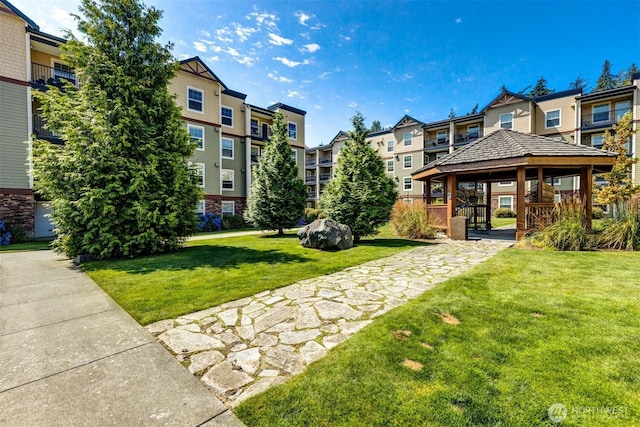 view of home's community with a gazebo, a yard, and a residential view