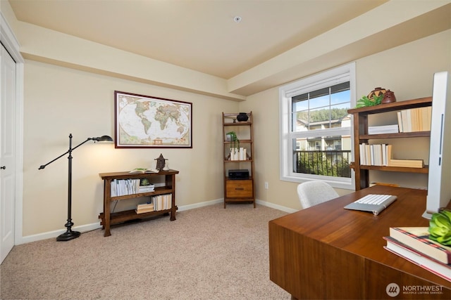 home office with light colored carpet and baseboards