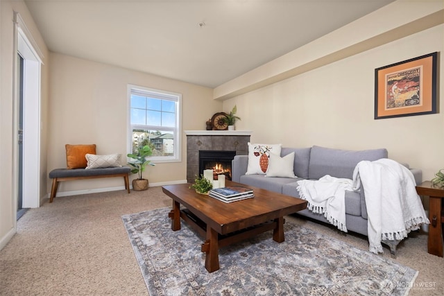 carpeted living area featuring baseboards and a tiled fireplace