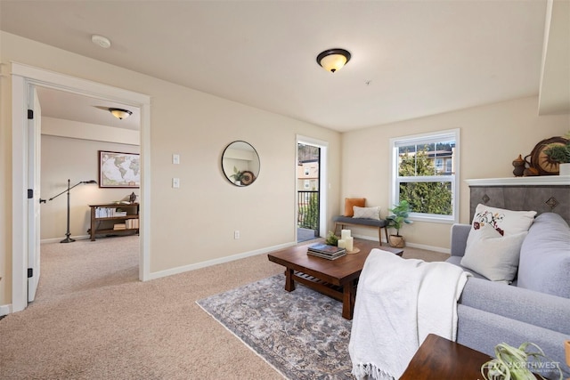 carpeted living area featuring baseboards