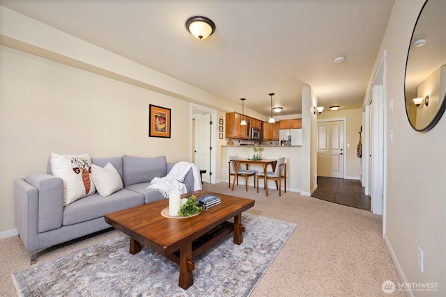 living room featuring baseboards and carpet