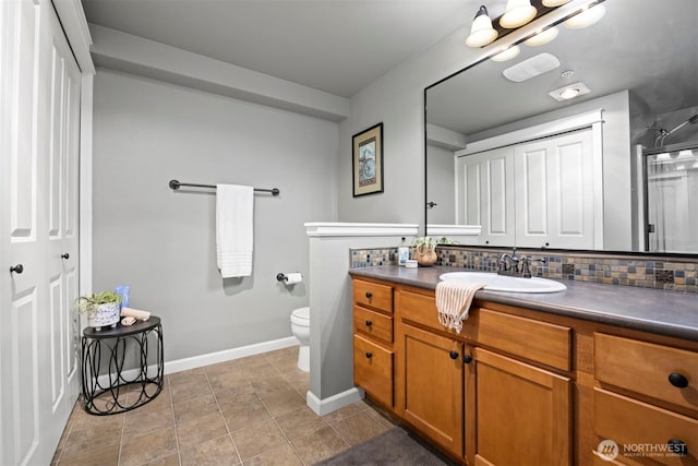 full bath featuring backsplash, baseboards, toilet, tile patterned floors, and vanity