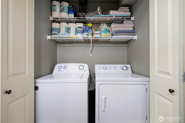 clothes washing area featuring laundry area and separate washer and dryer