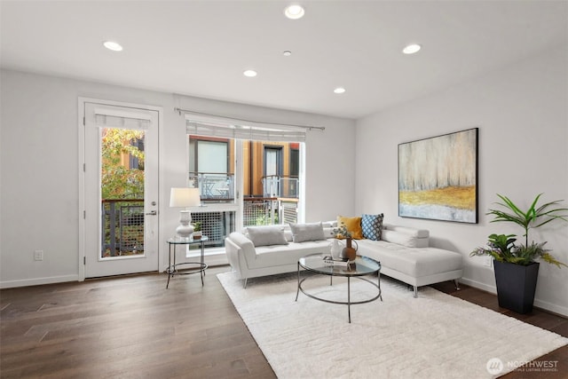 living area featuring recessed lighting, baseboards, and wood finished floors