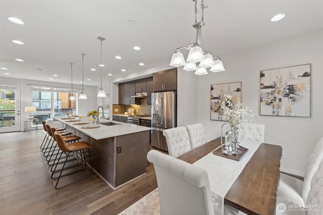 dining space featuring recessed lighting and wood finished floors