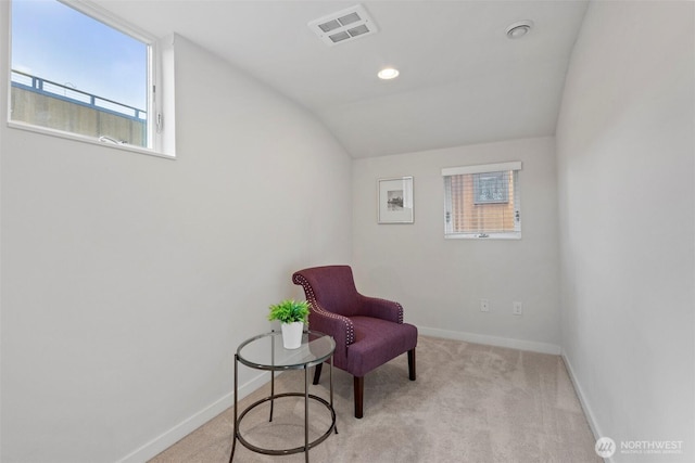 living area featuring vaulted ceiling, carpet flooring, baseboards, and visible vents