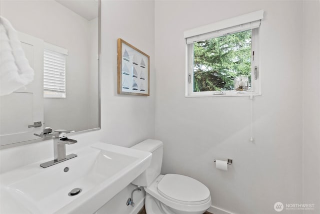 half bath with a sink and toilet