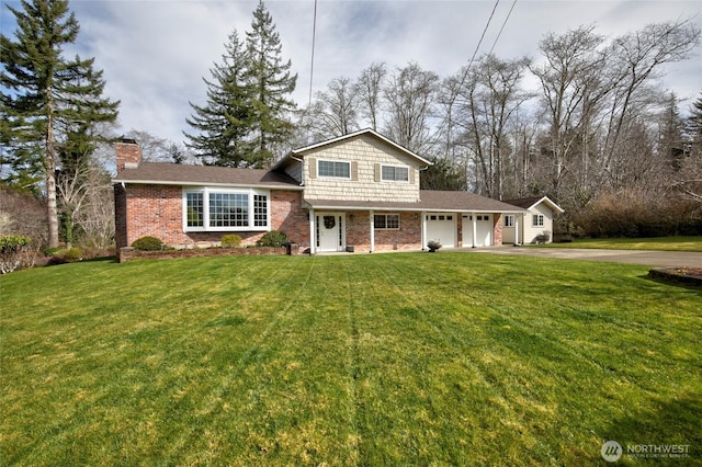 view of front of property with brick siding, aphalt driveway, a front yard, and an attached garage