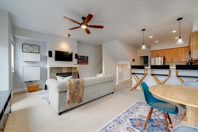 living area with recessed lighting, light colored carpet, a fireplace, and ceiling fan