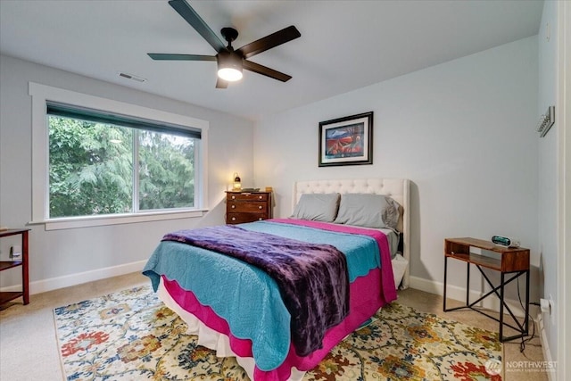 bedroom featuring ceiling fan, carpet, visible vents, and baseboards