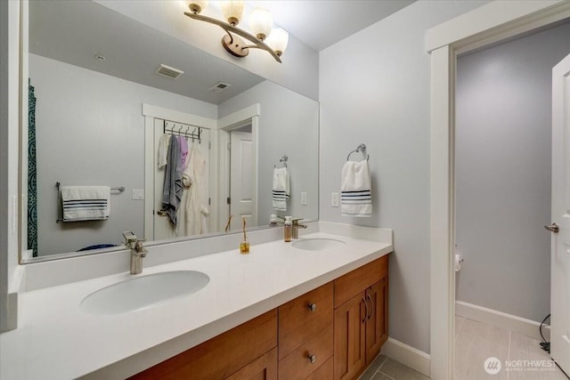 full bath with a sink, visible vents, and tile patterned flooring