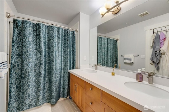 bathroom featuring double vanity, visible vents, curtained shower, and a sink