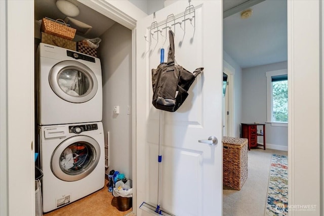 laundry area with laundry area, stacked washing maching and dryer, and carpet floors