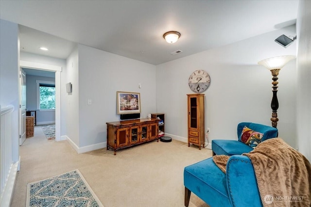 sitting room featuring baseboards, visible vents, and carpet floors