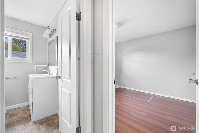 bathroom with vanity and baseboards