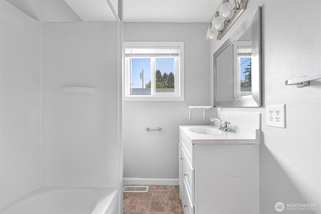 bathroom with visible vents, vanity, and baseboards