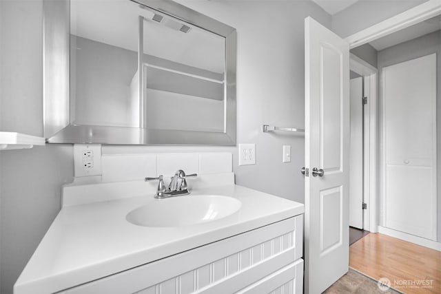 bathroom with vanity and wood finished floors