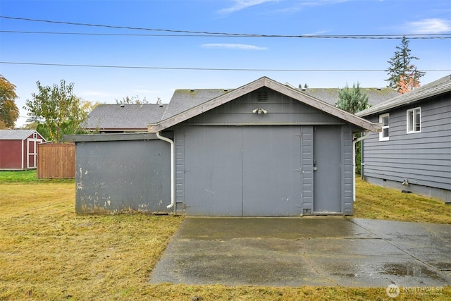 garage featuring a storage shed