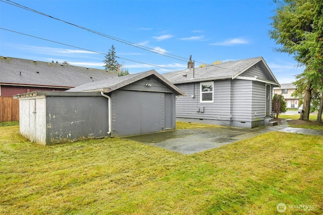 rear view of house featuring a patio area, crawl space, an outdoor structure, and a yard