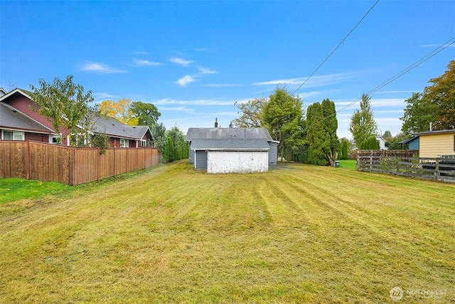 view of yard featuring an outdoor structure and fence