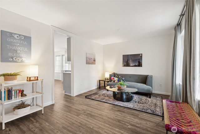 living area featuring baseboards and wood finished floors