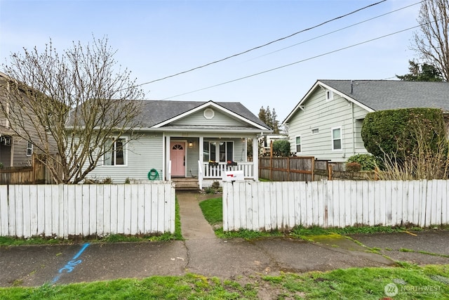 view of front of home featuring a fenced front yard and covered porch