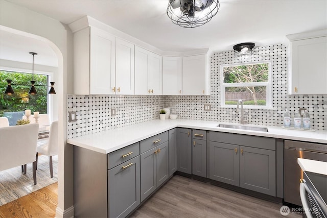 kitchen featuring gray cabinetry, a sink, tasteful backsplash, white cabinets, and light countertops