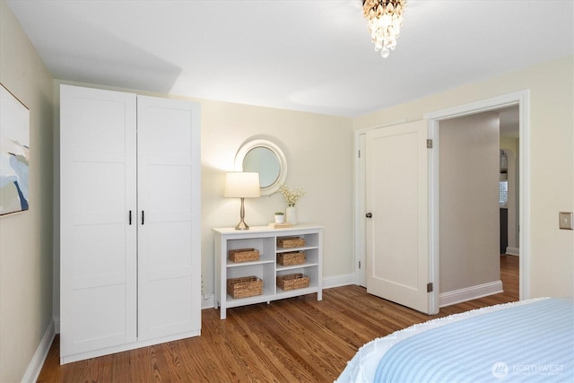 bedroom with wood finished floors and baseboards