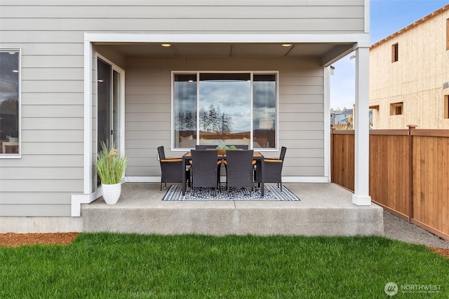 view of patio with outdoor dining area and fence