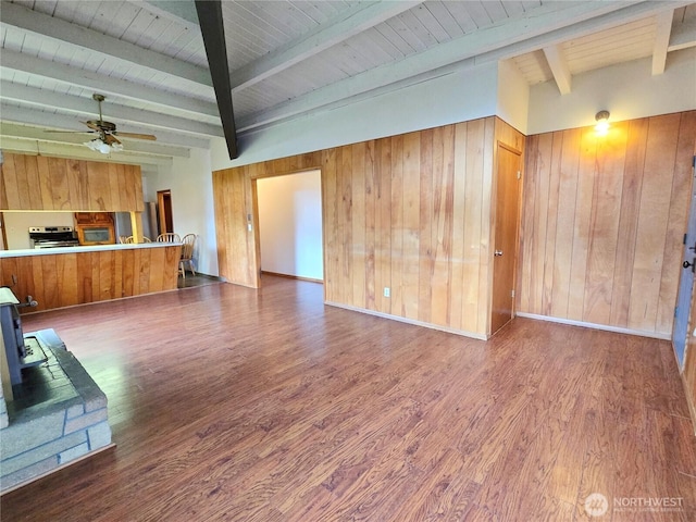 unfurnished living room with wood finished floors and wood walls