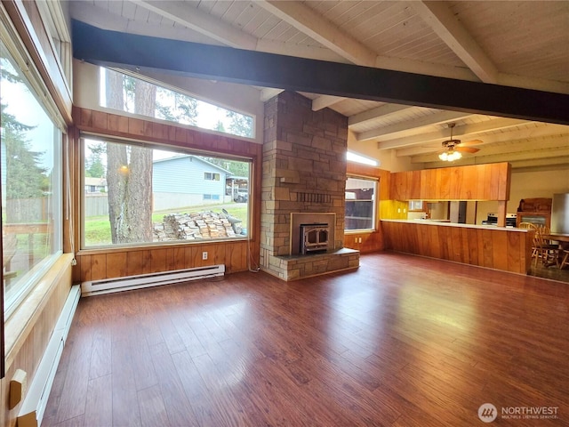 unfurnished living room featuring a ceiling fan, wood finished floors, a baseboard radiator, a stone fireplace, and baseboard heating