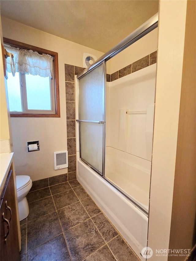 full bath featuring vanity, toilet, visible vents, and enclosed tub / shower combo