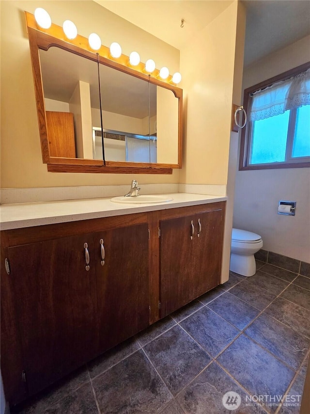 bathroom featuring toilet and vanity