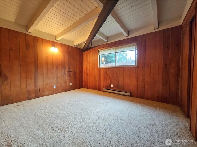 carpeted spare room featuring wooden walls, vaulted ceiling with beams, and baseboard heating