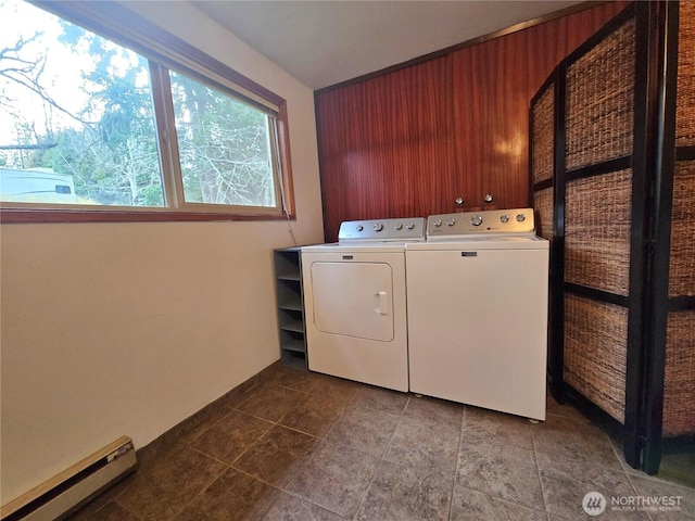 washroom with laundry area, washer and dryer, and a baseboard heating unit