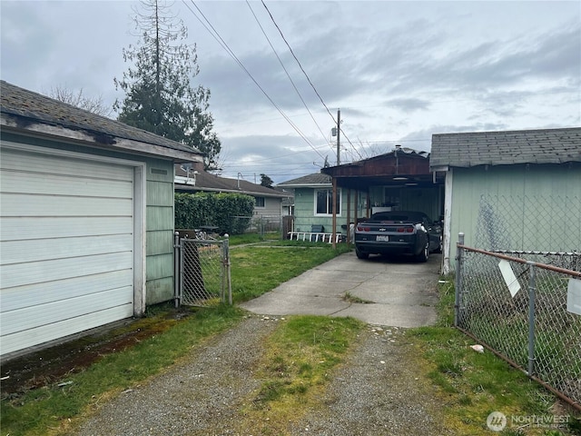 view of home's exterior featuring a carport, driveway, a gate, and fence