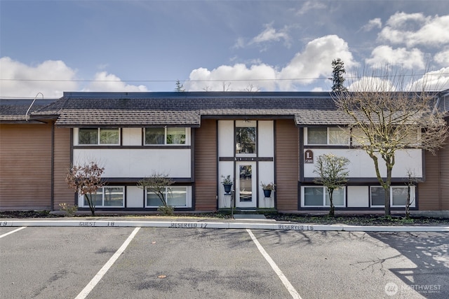 view of building exterior with uncovered parking